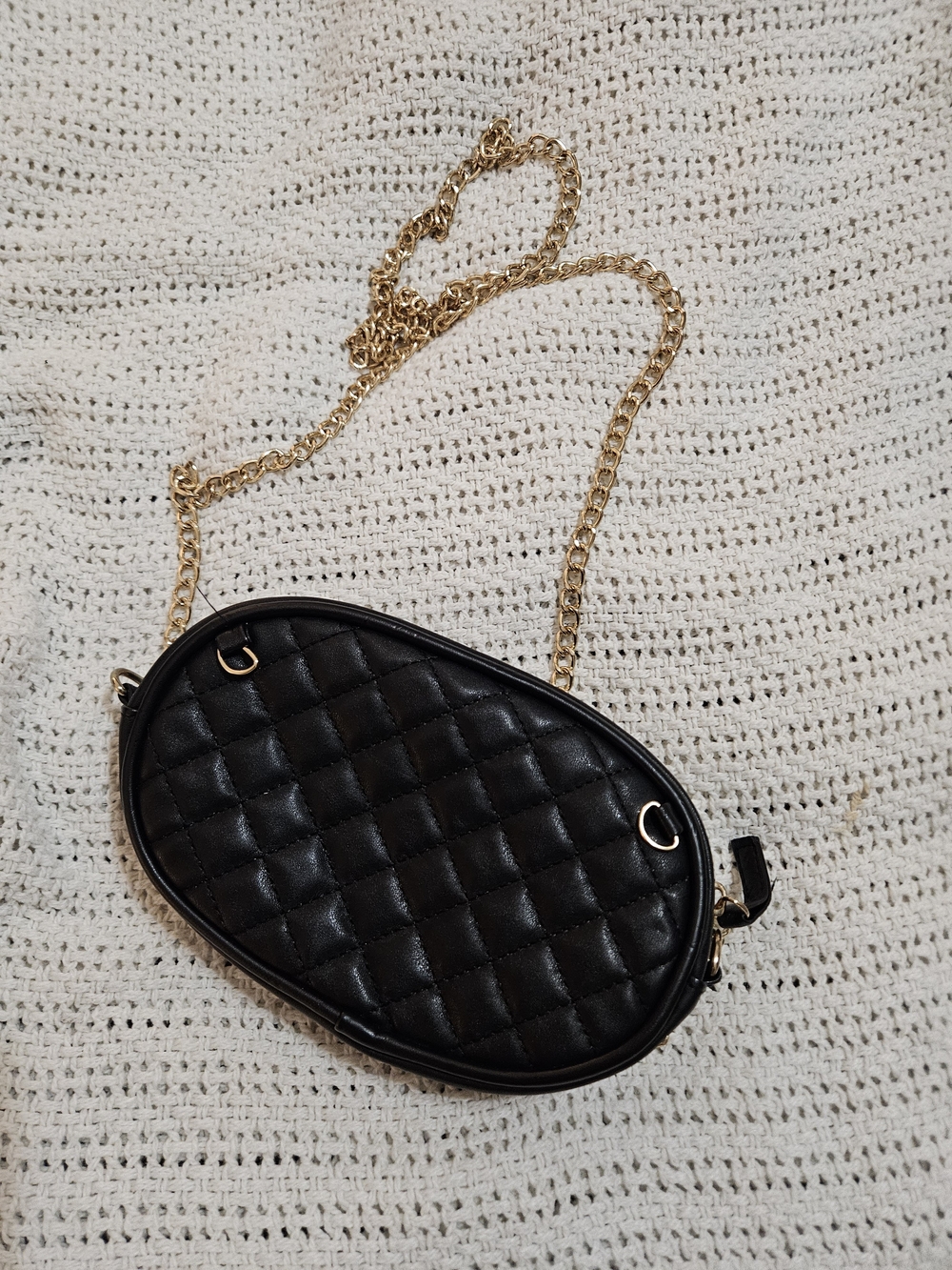 Quilted Black Oval Crossbody Bag with Gold Chain Strap